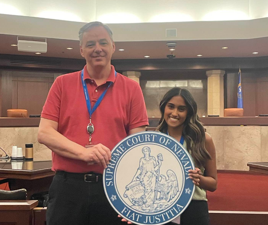 Intern and employee holding Nevada Supreme Court logo in courtroom